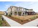 A charming two-story home has a cozy front porch, a picket fence, and a sidewalk lined with greenery at 129 Mesa Way, Superior, CO 80027