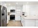 Modern kitchen with stainless steel appliances, white cabinets, and a convenient layout for cooking at 129 Mesa Way, Superior, CO 80027