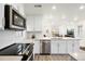Contemporary kitchen featuring stainless steel appliances, sleek white cabinetry, and quartz countertops at 129 Mesa Way, Superior, CO 80027