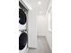Efficient laundry room with stacked washer and dryer and an open doorway at 129 Mesa Way, Superior, CO 80027
