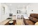 Bright, open-concept living space with modern finishes, wood floors, and a stylish kitchen bar at 129 Mesa Way, Superior, CO 80027