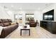 Inviting living room with plank flooring, comfortable seating, and a door leading to the outdoor living space at 129 Mesa Way, Superior, CO 80027
