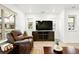 Bright living room featuring plank flooring, a large TV, and comfortable seating arrangement with lots of natural light at 129 Mesa Way, Superior, CO 80027