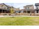 A neighborhood park is visible, with green grass, a sidewalk, and a picket fence lined with shrubs at 129 Mesa Way, Superior, CO 80027