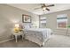 Bedroom with a queen-sized bed, ceiling fan, and matching nightstands at 1273 S Dallas Ct, Denver, CO 80247