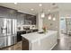 Modern kitchen with stainless steel appliances, pendant lights, and center island at 1273 S Dallas Ct, Denver, CO 80247