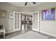 View of the living area through French doors, showing the dining table and sofa at 1273 S Dallas Ct, Denver, CO 80247
