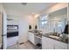 Bright bathroom boasts double sinks, sleek countertops, and a glimpse of the main bedroom at 4875 E 148Th Pl, Thornton, CO 80602