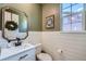 Charming powder room with white shiplap walls, a stylish mirror, and modern fixtures at 4875 E 148Th Pl, Thornton, CO 80602