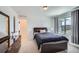 A bright bedroom features a dresser, a closet, and a large window at 4875 E 148Th Pl, Thornton, CO 80602