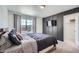 A modern bedroom features a board and batten accent wall and a TV at 4875 E 148Th Pl, Thornton, CO 80602