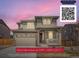 Charming two-story home featuring stone accents, a covered front porch, and a well-manicured lawn at 4875 E 148Th Pl, Thornton, CO 80602