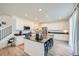Spacious kitchen boasts white cabinetry, black countertops, stainless steel appliances, and a large center island with bar seating at 4875 E 148Th Pl, Thornton, CO 80602