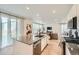 Modern kitchen with white cabinets, granite counters, stainless appliances, and large island with a sink at 4875 E 148Th Pl, Thornton, CO 80602
