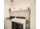 Laundry area with white cabinets and modern appliances at 4875 E 148Th Pl, Thornton, CO 80602
