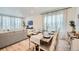 Open-concept living space with a dining area, comfortable seating, and large windows that let in natural light at 4875 E 148Th Pl, Thornton, CO 80602