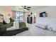 Main bedroom featuring a ceiling fan, plush carpet, and an ensuite bathroom at 4875 E 148Th Pl, Thornton, CO 80602