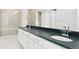 Bathroom featuring double sinks, modern cabinetry, and a glass-enclosed shower at 10730 Hanging Lake Pl, Parker, CO 80138