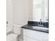 Stylish bathroom with a sleek white vanity, modern faucet, and a luxurious white tile bathtub and shower at 10730 Hanging Lake Pl, Parker, CO 80138