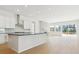 Bright, open kitchen featuring white cabinets, an island, and seamless access to the living area at 10730 Hanging Lake Pl, Parker, CO 80138