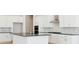 Modern kitchen featuring white cabinets, stainless steel appliances, and a center island at 10730 Hanging Lake Pl, Parker, CO 80138