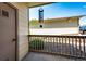 Enclosed balcony featuring wooden railing and view to yard at 5439 S Dover St # 101, Littleton, CO 80123