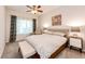 Cozy bedroom with soft carpet, neutral walls, and a large window with a ceiling fan at 5439 S Dover St # 101, Littleton, CO 80123
