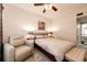 Comfortable bedroom showcasing neutral carpet, a seating area and a large window at 5439 S Dover St # 101, Littleton, CO 80123