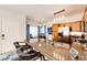 Kitchen featuring granite countertops, stainless appliances, and a bar area for casual dining, leading into a dining area at 5439 S Dover St # 101, Littleton, CO 80123