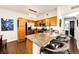 Modern kitchen with stainless appliances, granite countertops, and bar seating, seamlessly flowing into the living area at 5439 S Dover St # 101, Littleton, CO 80123