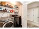 Functional laundry room equipped with modern washer and dryer units and ample storage shelves at 5439 S Dover St # 101, Littleton, CO 80123