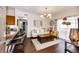Stylishly decorated living room featuring a modern chandelier, comfortable seating, and an open layout to the kitchen at 5439 S Dover St # 101, Littleton, CO 80123