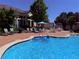 Community pool with lounge chairs and tables; perfect for relaxation and recreation at 5439 S Dover St # 101, Littleton, CO 80123