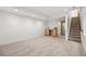 Spacious finished basement with a wet bar, carpeted floors, and a staircase to the upper level at 1735 Lowell Blvd, Denver, CO 80204