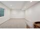 Unfurnished basement featuring neutral carpet and walls, and a bright egress window at 1735 Lowell Blvd, Denver, CO 80204