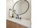 Modern bathroom featuring an oval mirror, elegant sink, and quartz countertops providing a stylish and functional space at 1735 Lowell Blvd, Denver, CO 80204