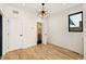 Bright bedroom with modern lighting, hardwood floors, and a window providing natural light creating a calm space at 1735 Lowell Blvd, Denver, CO 80204