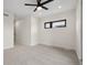 This bedroom features neutral walls, carpet, a modern ceiling fan, and a black framed window at 1735 Lowell Blvd, Denver, CO 80204