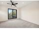 Bright bedroom with neutral carpet and walls, a black ceiling fan, and access to a private balcony at 1735 Lowell Blvd, Denver, CO 80204
