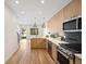 Bright kitchen featuring stainless steel appliances, sleek cabinetry, and hardwood flooring at 1735 Lowell Blvd, Denver, CO 80204