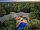 Luxury estate aerial view showcasing private pool, landscaped grounds, and architectural roofline amid lush surroundings at 4766 S Fillmore Ct, Cherry Hills Village, CO 80113