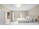 Neutral bedroom with twin beds, soft carpet, and a large window offering natural light and relaxing ambiance at 4766 S Fillmore Ct, Cherry Hills Village, CO 80113