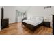 Bedroom offers a cozy atmosphere with wood floors, a large window, and classic furniture pieces at 4766 S Fillmore Ct, Cherry Hills Village, CO 80113