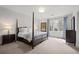 Comfortable bedroom with soft carpet, a four-poster bed, and serene views from the bright window at 4766 S Fillmore Ct, Cherry Hills Village, CO 80113
