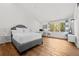 Inviting bedroom with wood floors, a neutral color palette, and a large window to maximize natural light at 4766 S Fillmore Ct, Cherry Hills Village, CO 80113