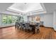 Elegant dining room featuring hardwood floors, a modern light fixture, and large windows at 4766 S Fillmore Ct, Cherry Hills Village, CO 80113