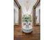 Grand foyer boasts soaring ceilings, wooden floors, stone columns, and a striking chandelier creating a dramatic entrance at 4766 S Fillmore Ct, Cherry Hills Village, CO 80113