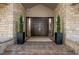 Exterior front entrance showing stone details and landscape at 4766 S Fillmore Ct, Cherry Hills Village, CO 80113