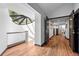 Hallway with skylight bringing natural light, hardwood floors, and dark trim throughout the home at 4766 S Fillmore Ct, Cherry Hills Village, CO 80113