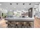 Open concept kitchen with stone accents, stainless hood and large island at 4766 S Fillmore Ct, Cherry Hills Village, CO 80113